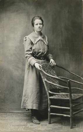 Jennie Roberts at the time her husband left to serve in the US Army in World War I. She is standing behind a large empty wicker chair