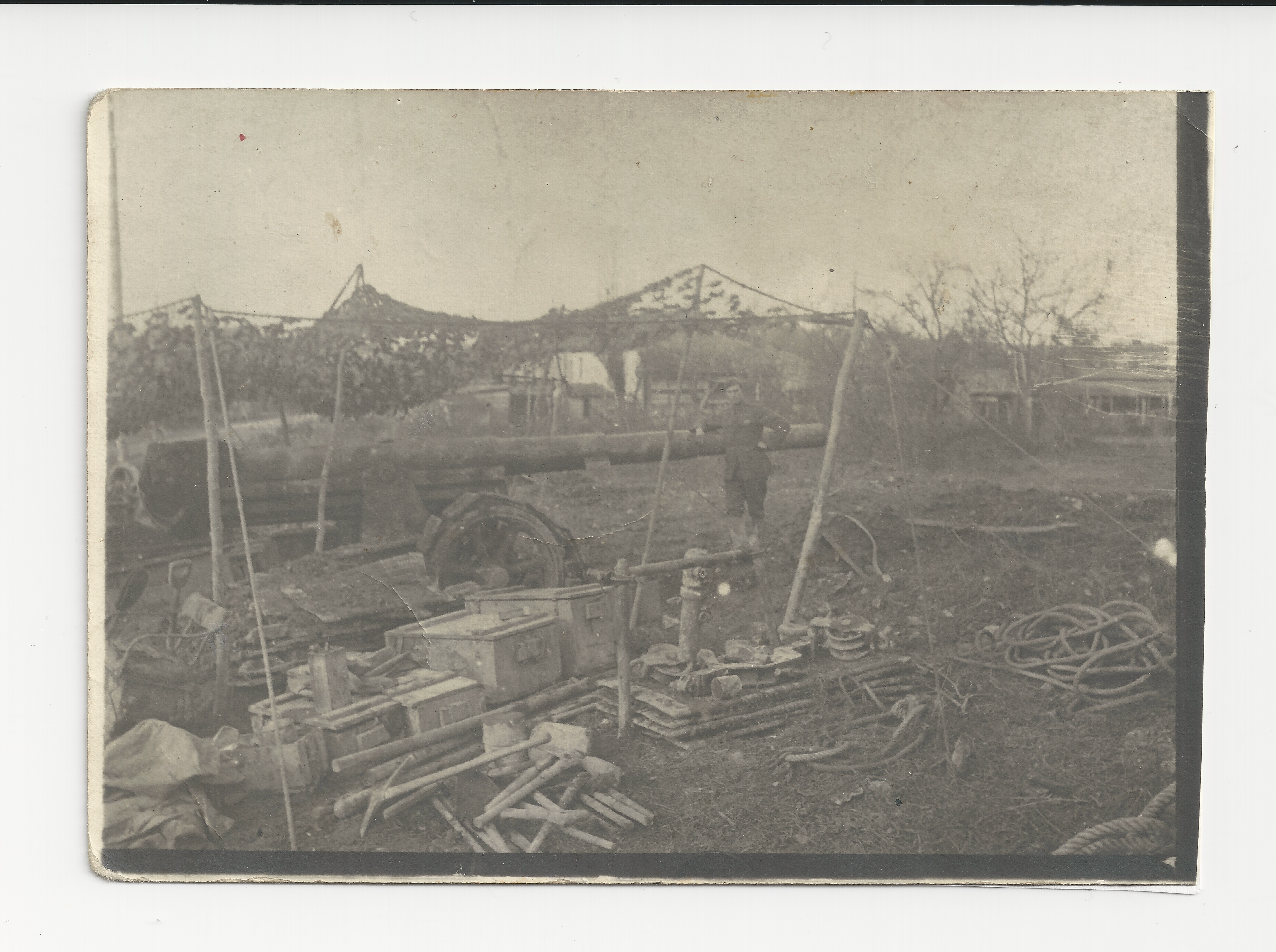 Sam Roberts standing in front of his big gun on a battlefield in France.